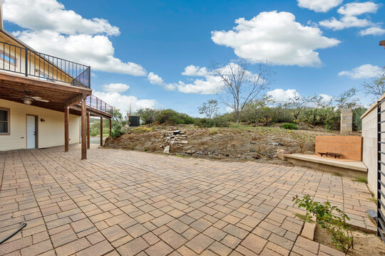 Brick-paved patio and desert backyard