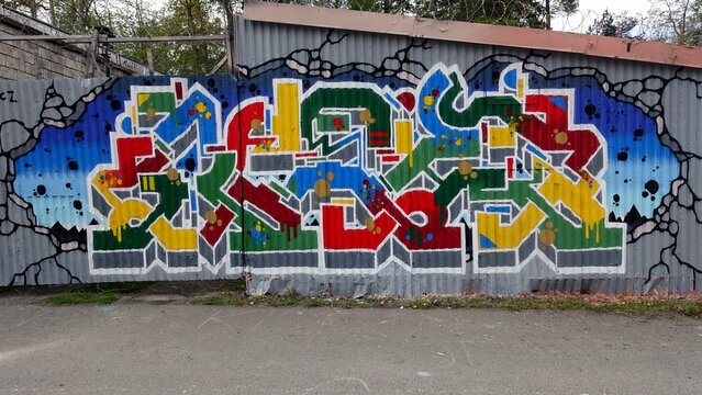 Stockholm, Sweden, may 17, 2026. Colorful Graffiti Mural on Corrugated Metal Wall. Urban Street Art Spray Paint Artwork
