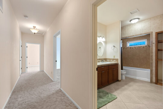 Bright hallway with adjacent bathroom and vanity area