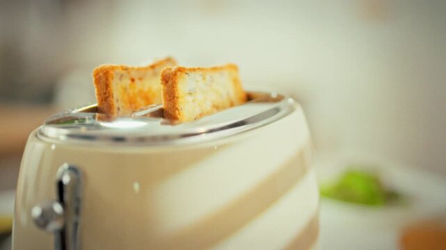 In a bright kitchen, a vintage toaster pops up golden toast, the sliced bread springing out as it finishes cooking. The warm aroma fills the room, highlighting simple, classic breakfast preparation
