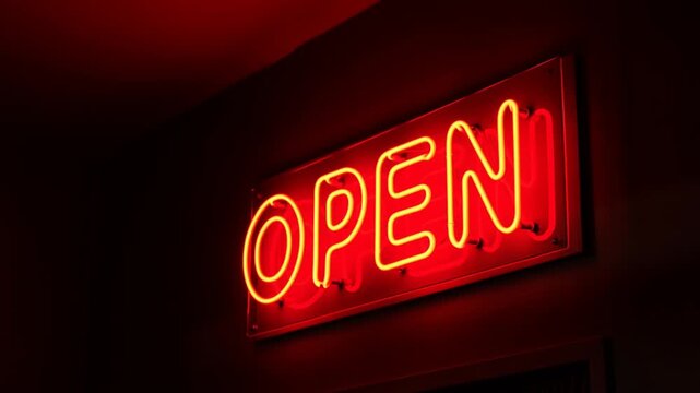 Zoom in on neon open sign revealing red glowing letters on dark interior wall in storefront entrance with slow tracking pan toward illuminated sign