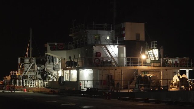 夜の港に停泊し強い照明に照らされる大型船舶のブリッジとデッキの4K動画
