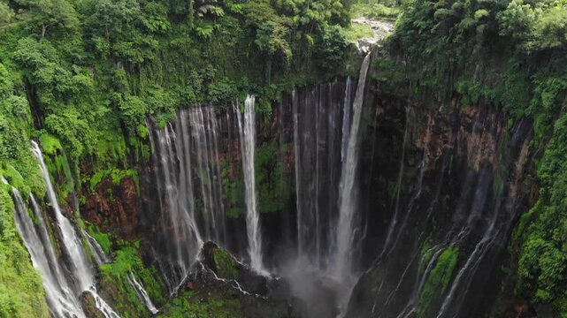 Aerial Drone Flying Through Jungle Canopy Towards Tumpak Sewu Waterfall, Java, Indonesia