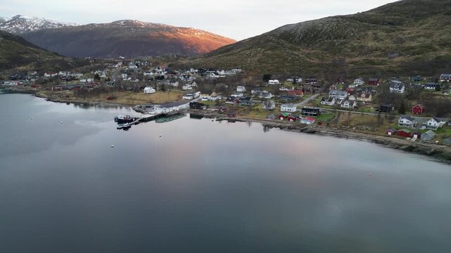 Aerial Drone Panning Over Perfectly Still Lake Reflecting Town and Sunset Glow, Troms&oslash;, Norway