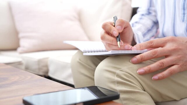 Professional writing notes for project planning and information review. Business documentation, decision making, work organization, goal setting and professional development concept.
