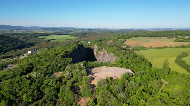 Experience the vastness of Velka Amerika, an abandoned limestone quarry near Prague. Surrounded by rich greenery, this location offers stunning views and a glimpse into nature's reclamation.