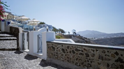 Obraz premium Coastal terrace and stone walkway in soft sunlit blurred bokeh, path; background backdrop copyspace calm.
