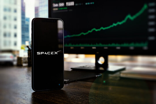 SpaceX Logo Displayed On Smartphone Screen, Space Exploration Technologies Corp IPO (Initial Public Offering), Green Stock Exchange Market Trading Chart, SPCX IPO, London, UK - June 2026