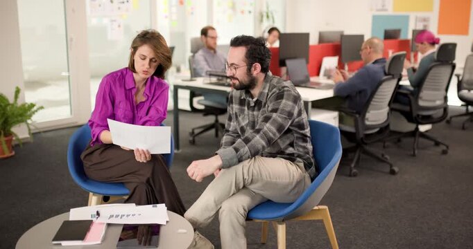 Business team discusses project plans in modern office setting with focus on collaboration and teamwork for effective outcomes