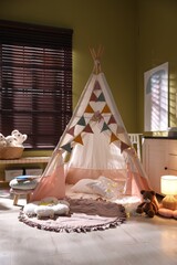 Beautiful wigwam, cushions and toys in child's room © New Africa