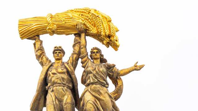 Moscow, Russia, May 04, 2026: Golden statues of two figures lift a wheat sheaf