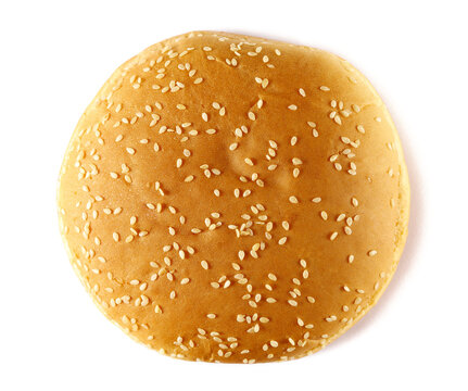 Burger bun with sesame seeds isolated on white background, top view