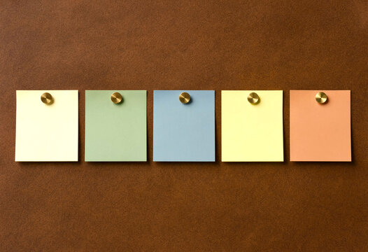 Blank sticky notes pinned on corkboard minimalist flat lay neutral colors