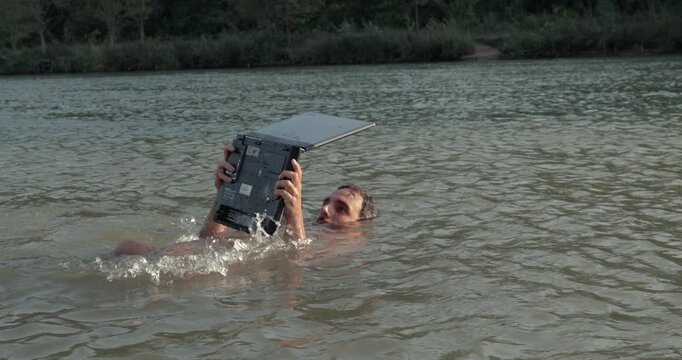 Using work laptop on the beach, in the water