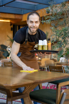 Friendly server cleaning table with yellow cloth