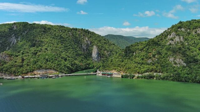 Aerial view of stone carved statue portrait of ancient dacian king Decebal. Sculpture located on shore of Danube River, Romania, 4k