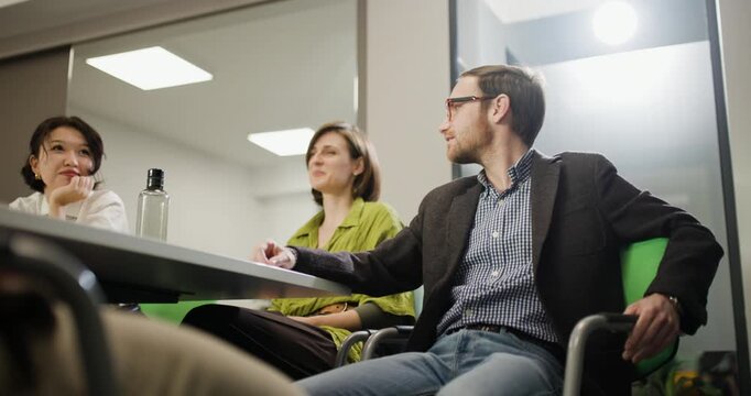 Business team discussion in office with diverse members sharing ideas and strategies in a collaborative setting during working hours