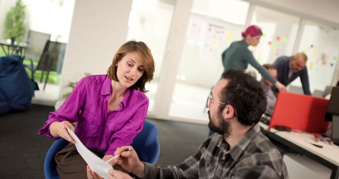 Team meeting in office with business people discussing ideas and plans during work hours in a modern workspace with collaborative atmosphere