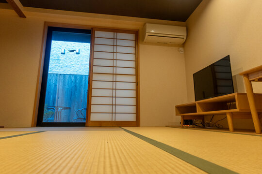 Comfortable Japanese tatami room with sliding doors and modern amenities for relaxation and tranquility
