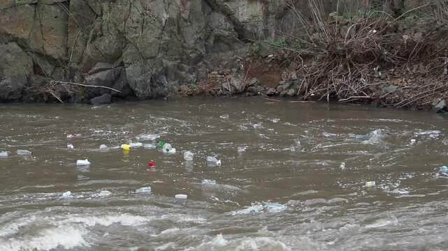 urban garbage floats in whirlpool of city river