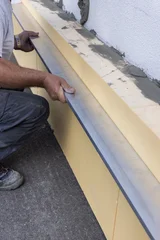 Inspecting the level of insulation boards on exterior walls © Brilliant Eye