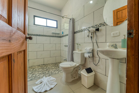 Clean modern bathroom interior design with shower and sink