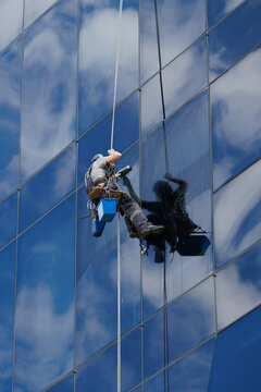 Industrial climber cleaning glass facade