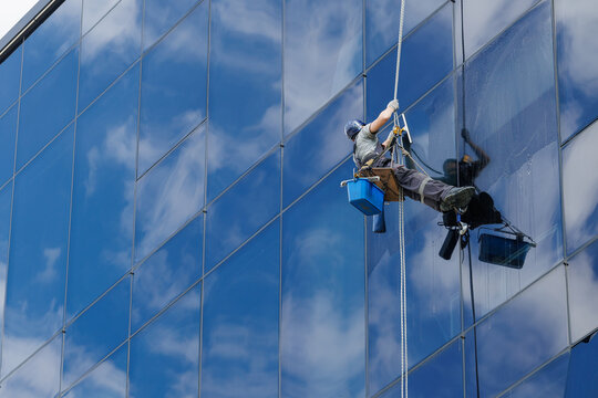 High-rise window cleaner washing skyscraper facade