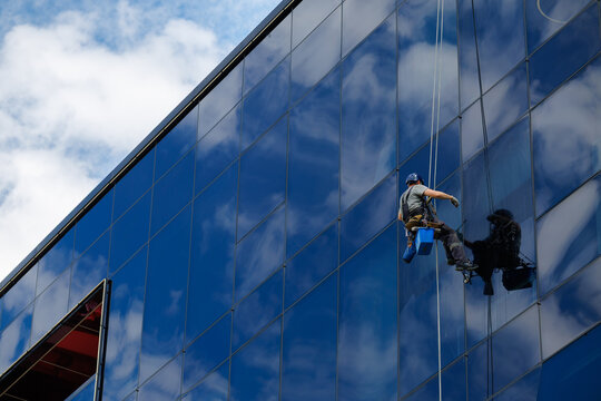 Industrial climber cleaning glass facade
