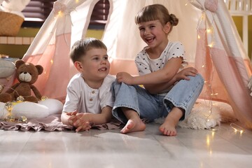 Little girl and boy near wigwam at home © New Africa