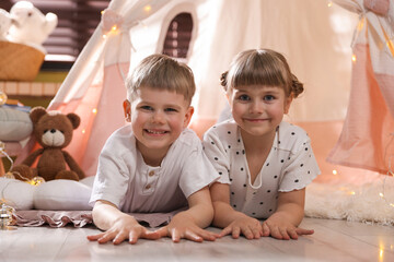 Little girl and boy near wigwam at home © New Africa
