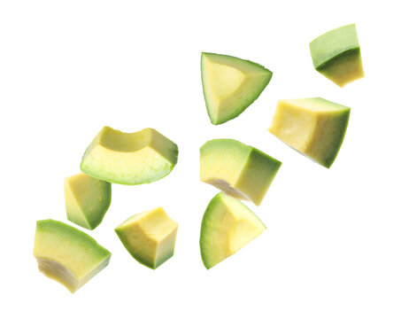 Fresh avocado pieces falling on transparent background