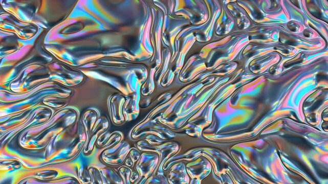 Slow panning shot of iridescent liquid metal surface morphing and flowing across glossy reflective texture in studio close up macro loop