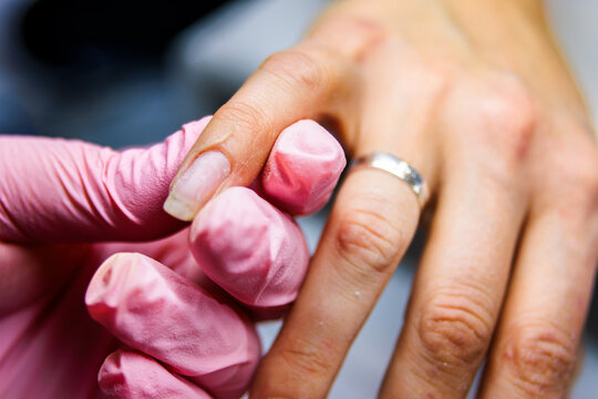 Manicurist working on client fingernails in beauty salon for grooming and aesthetics