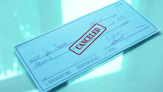 Cheque document canceled hand stamps seal on official paper insufficient funds in 4K Ultra HD footage.
