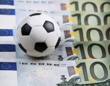 Football on euro notes, symbolic image for a betting scandal in professional soccer sport, AI generated