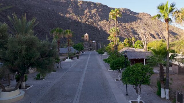 Discover the beauty of San Javier Mission in Baja California Sur Mexico as the sun rises over the historic site and palm trees