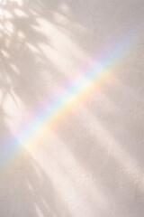Naklejka premium Soft pastel rainbow reflecting on a textured white wall