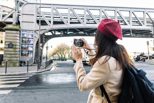 Woman traveling solo exploring paris bir hakeim bridge