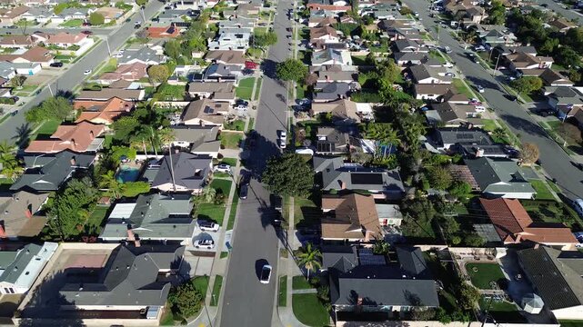 Blocks surrounding Talbert Ave Bushard St show aligned parcels, consistent midcentury housing near Fountain Valley, Orange County west edge. Mixed roofing hues, scattered trees, gentle light, CA