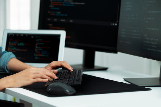 Cropped hands image of IT developer creating with typing information on pc with coding program information data website application, wearing jeans shirt surround safety analysis two screen. Stratagem.