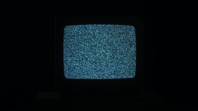 Retro TV, vintage television In a nostalgic setup, a retro TV displays grain on screen, scary halloween night device good for chroma key and green screen