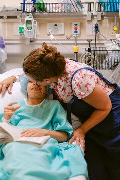 Mother Supports Son Hospital Reading Book