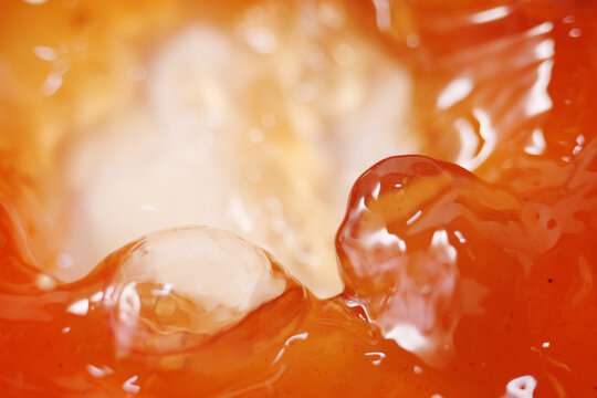 Close up of apple cider vinegar liquid. It made by fermenting apples can help with weight loss efforts, lower sugar cravings and reduce bloating