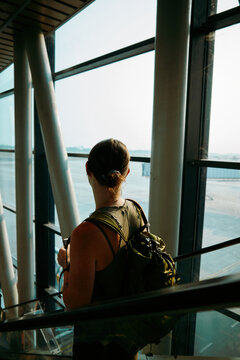 Descending an escalator in a bustling airport