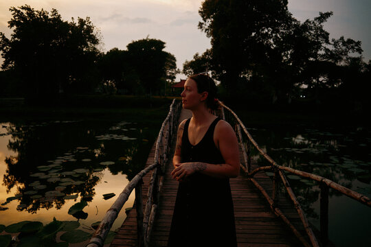 Strolling on a wooden bridge at dusk in tranquil Vietnam