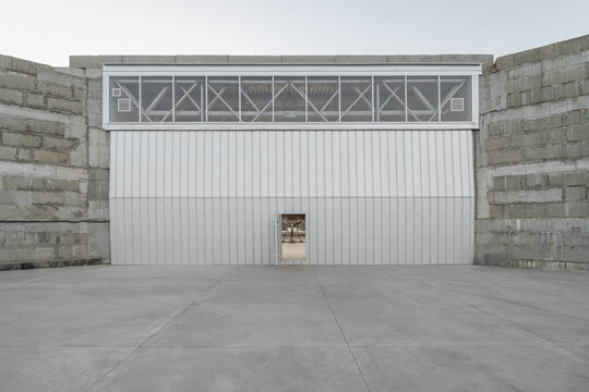 Minimalist Hangar Exterior with Framed Aircraft View