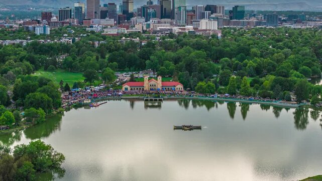 City park sunset reveal with Denver skyline concert drone hyperlapse Colorado 4K