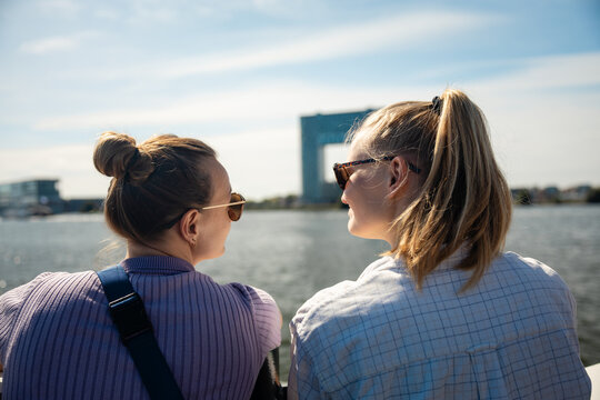 Lesbian couple enjoying waterfront view