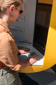 Woman exchanging cash at cashpoint 